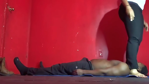 A sexy ebony chick stretches her breasts on a platform