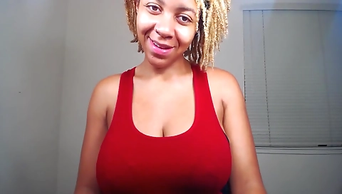 Ebony chick with large tits shows her ass on webcam
