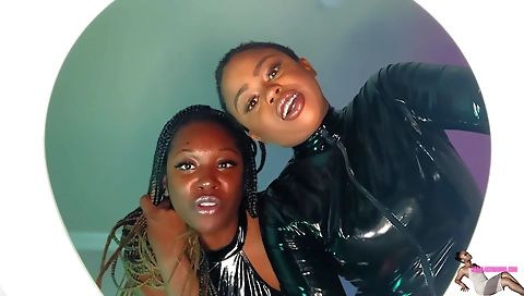 Latexed brunette shows off her big ass in the toilet