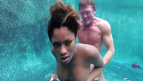 Ebony milf with big tits and a sexy smile is giving a facial