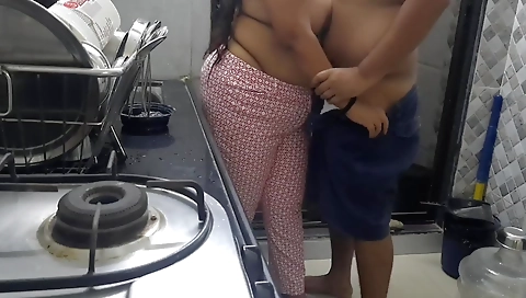 Ebony beauty in a black dress gets fucked in the kitchen